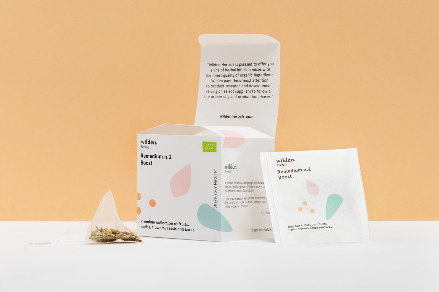 Square open package of herbal infusion Remedium Boost with single tea bag and herbs